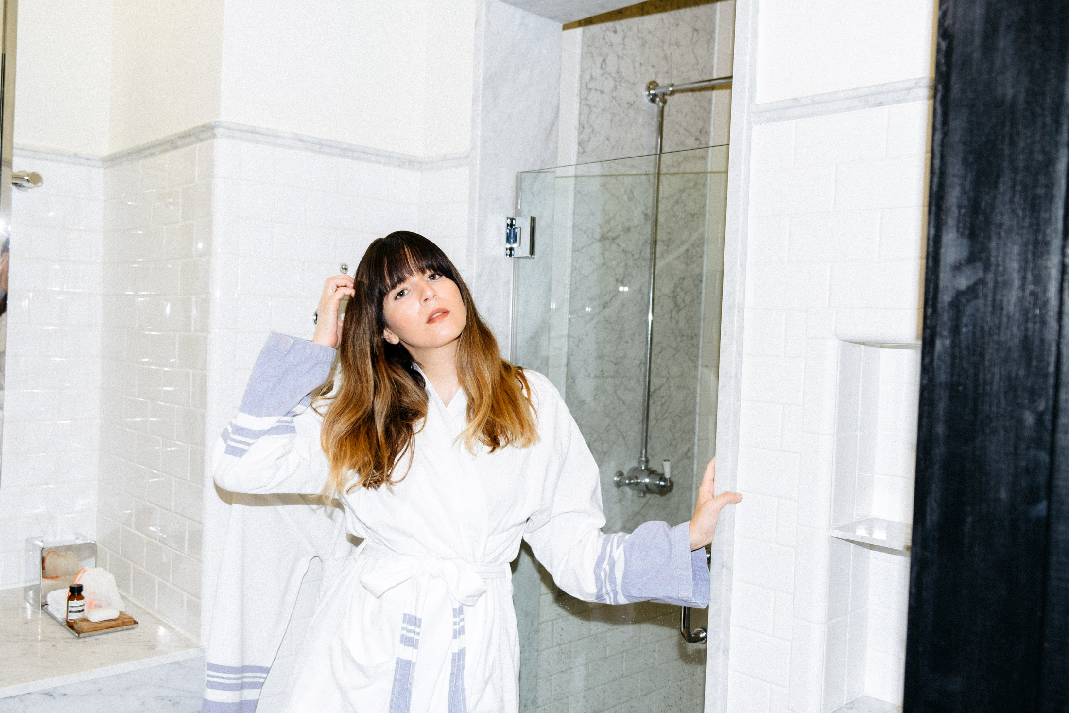 Maristella in the carrara marble decorated bathroom of the American Trade Hotel