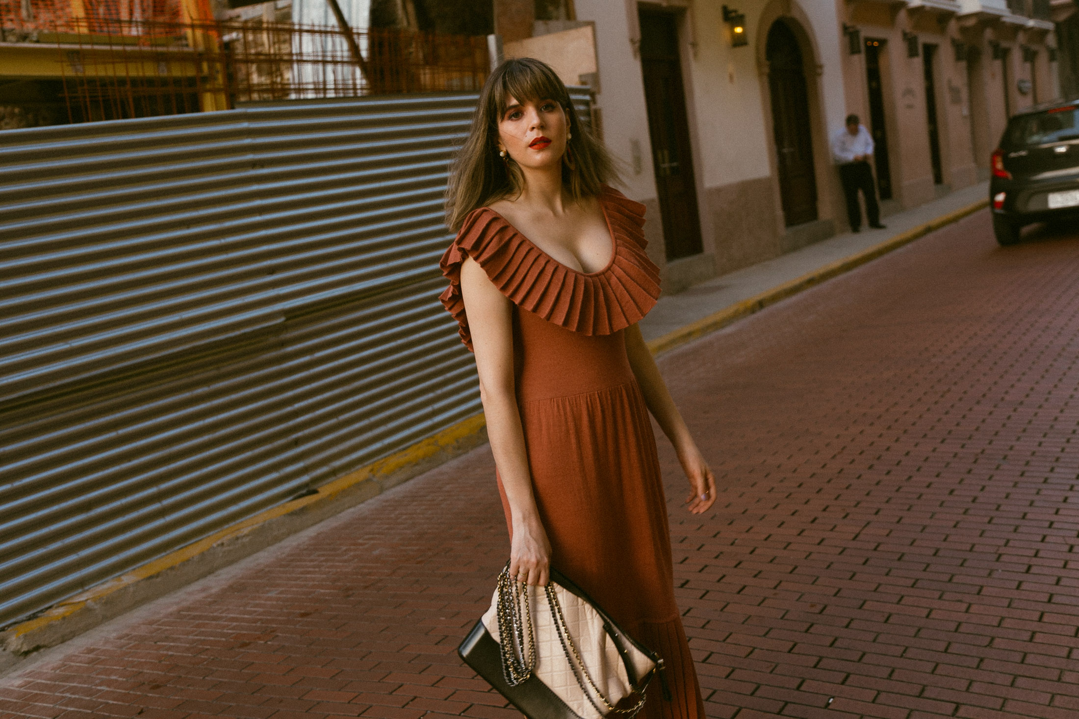 Maristella wears a beautiful terracotta color knit dress