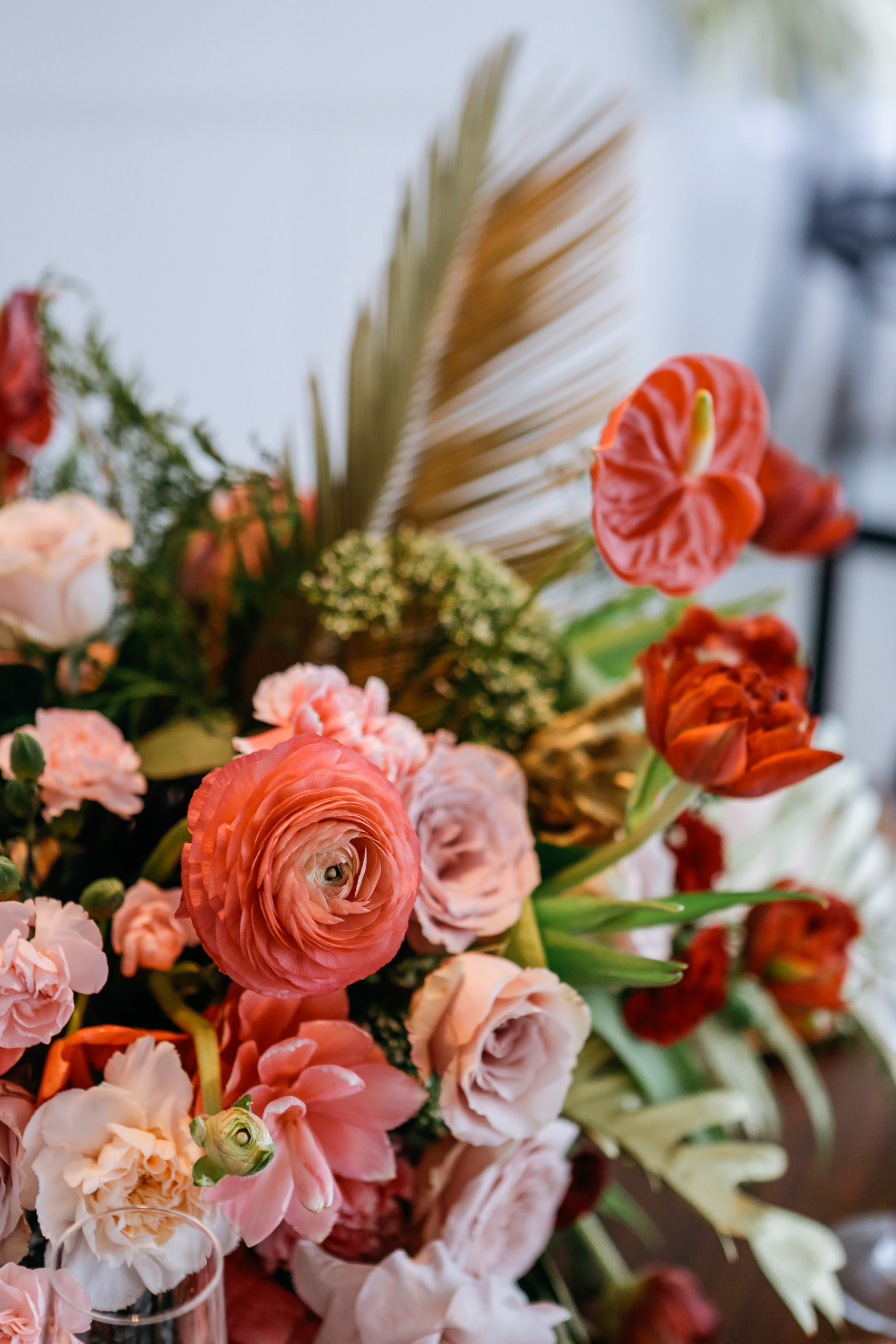 Ranunculus, rose, ginger, carnations, anthurium, pine, monstera and palm floral arrangement for Christmas