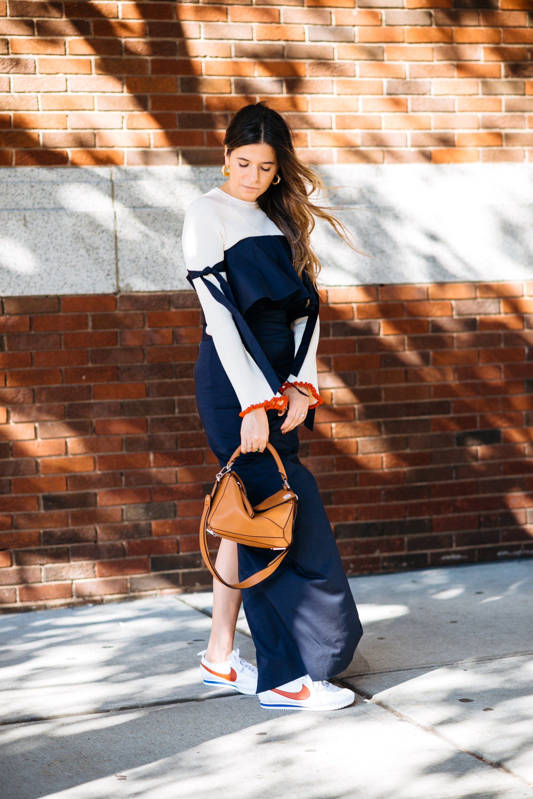 Maristella wearing Nike Cortez sneakers with a long elegant dress