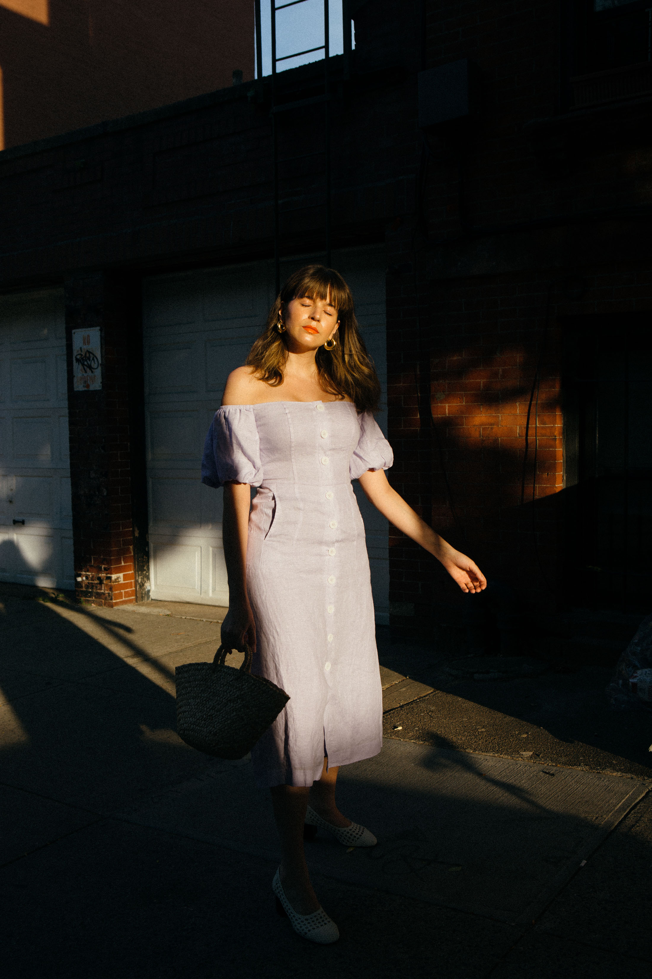 Maristella wears a linen midi dress from Kitri Studio