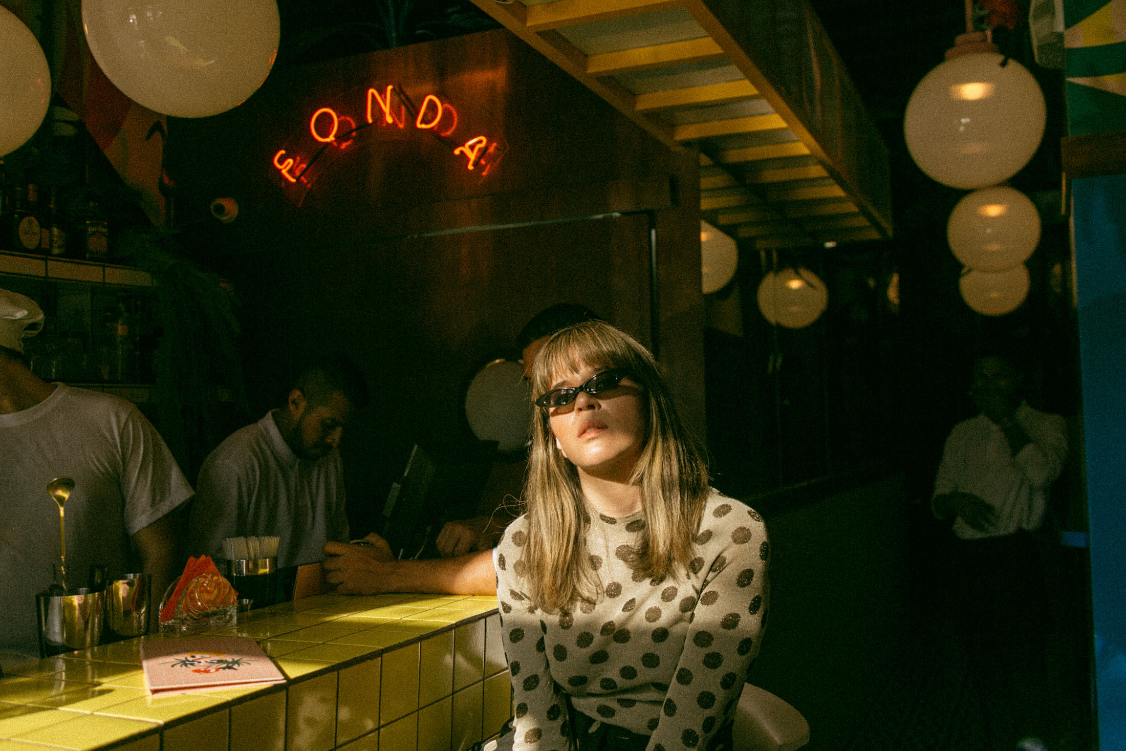 Maristella wears a Nanushka dot knit sweater and Giant Vintage sunglasses at Fonda Paraiso in Panama