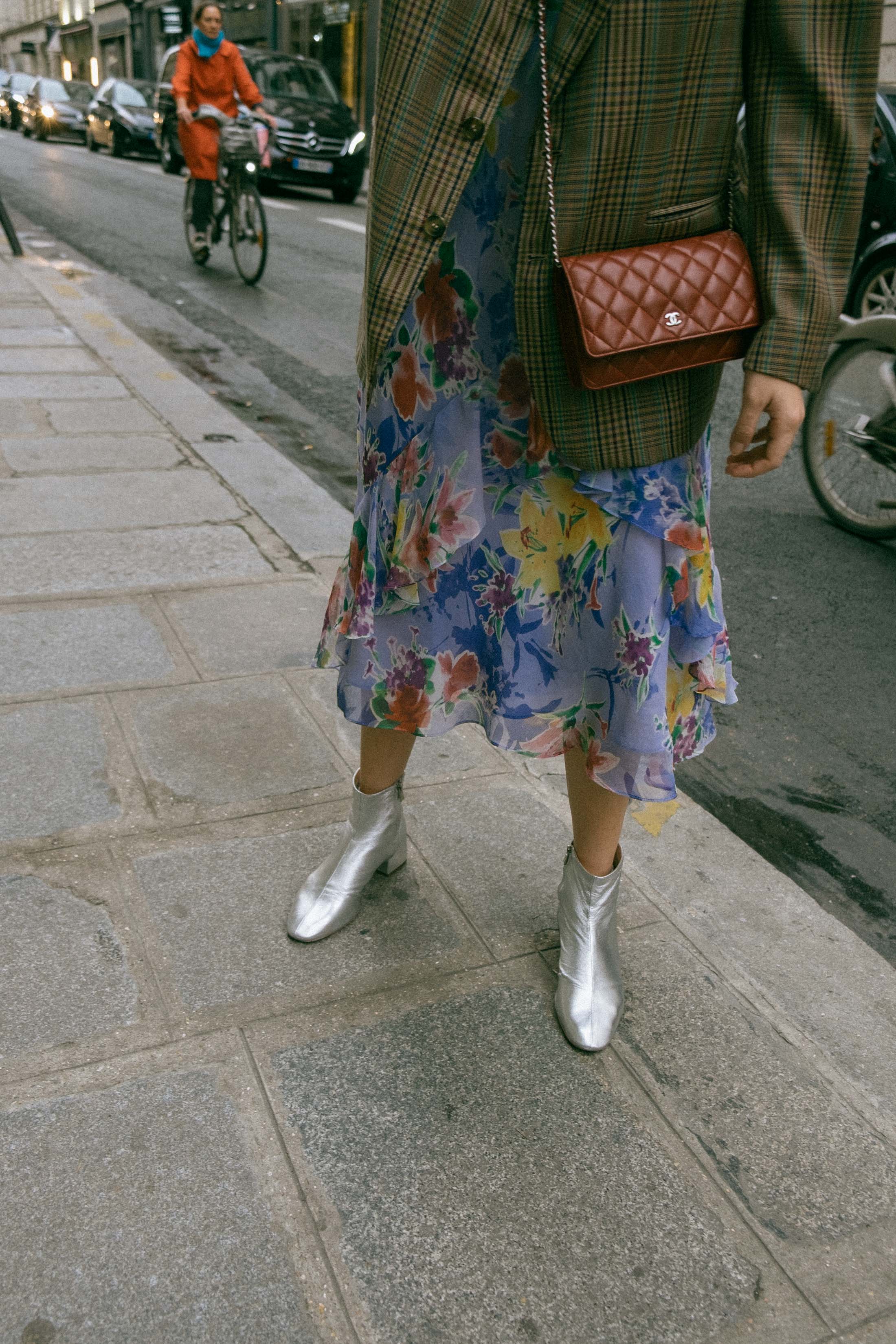 Maristella wears a vintage men's blazer, vintage floral dress, Loeffler Randall silver boots and mini burgundy Chanel crossbody bag in Paris