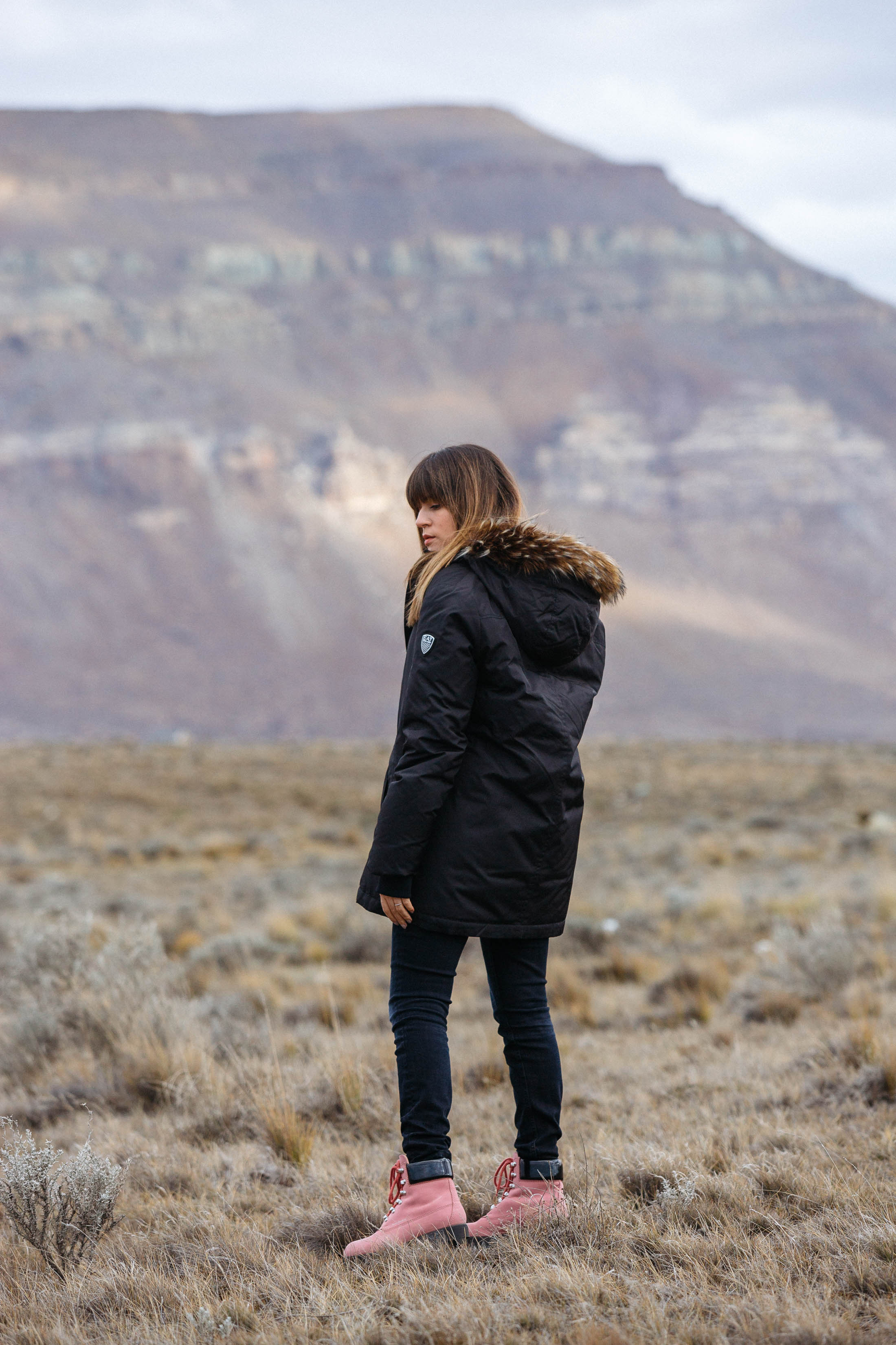 Maristella wears a black hooded parka from Armani, Calvin Klein skinny jeans and Acne pink Telde boots