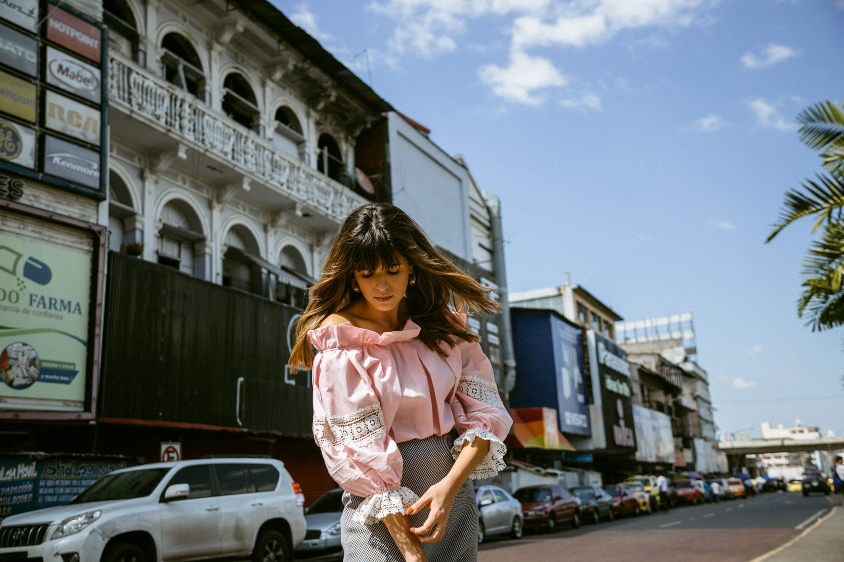 Maristella wearing a pink Style Mafia blouse with a vintage gingham skirt