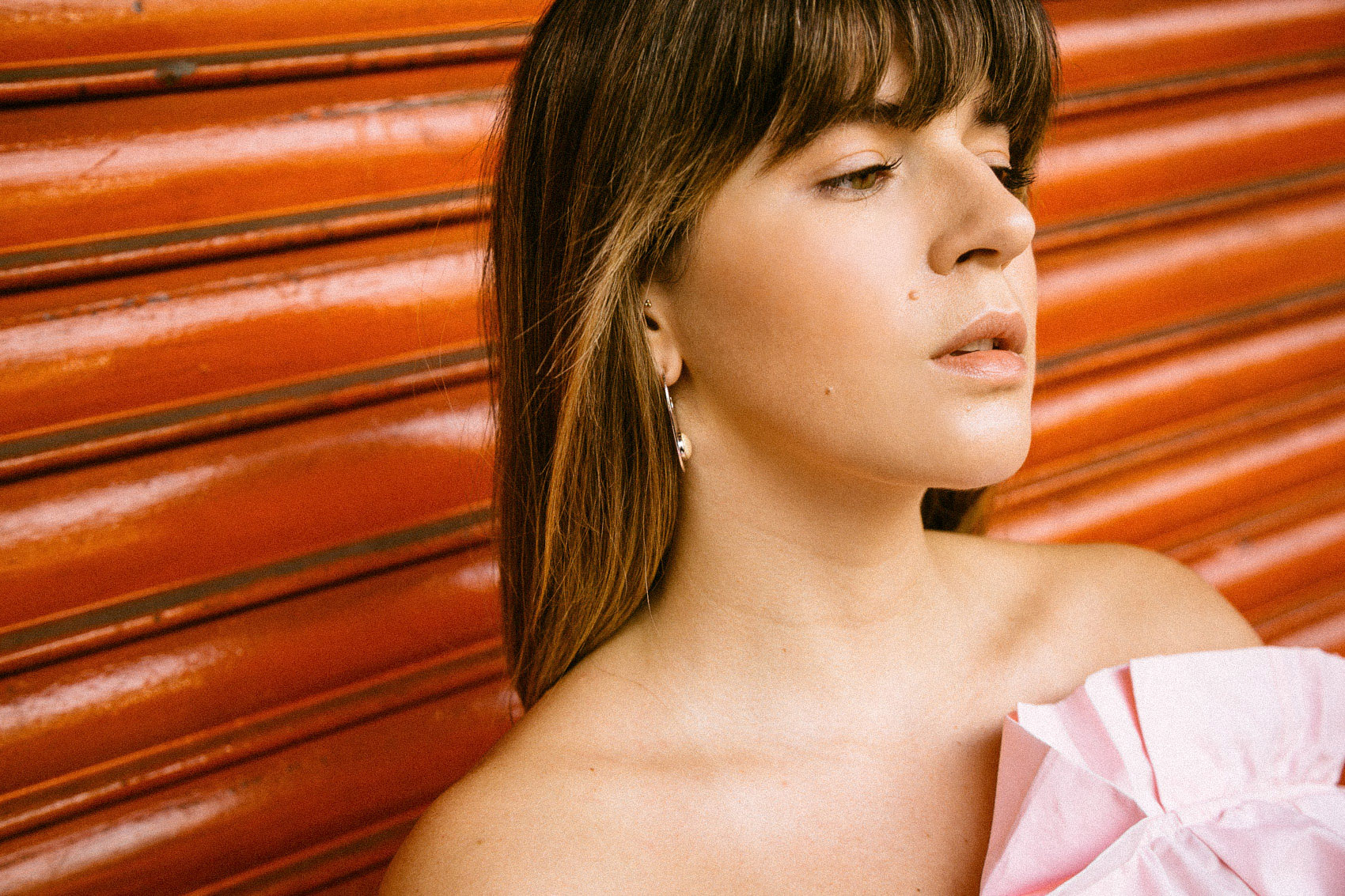 Statement earrings and bangs haircut