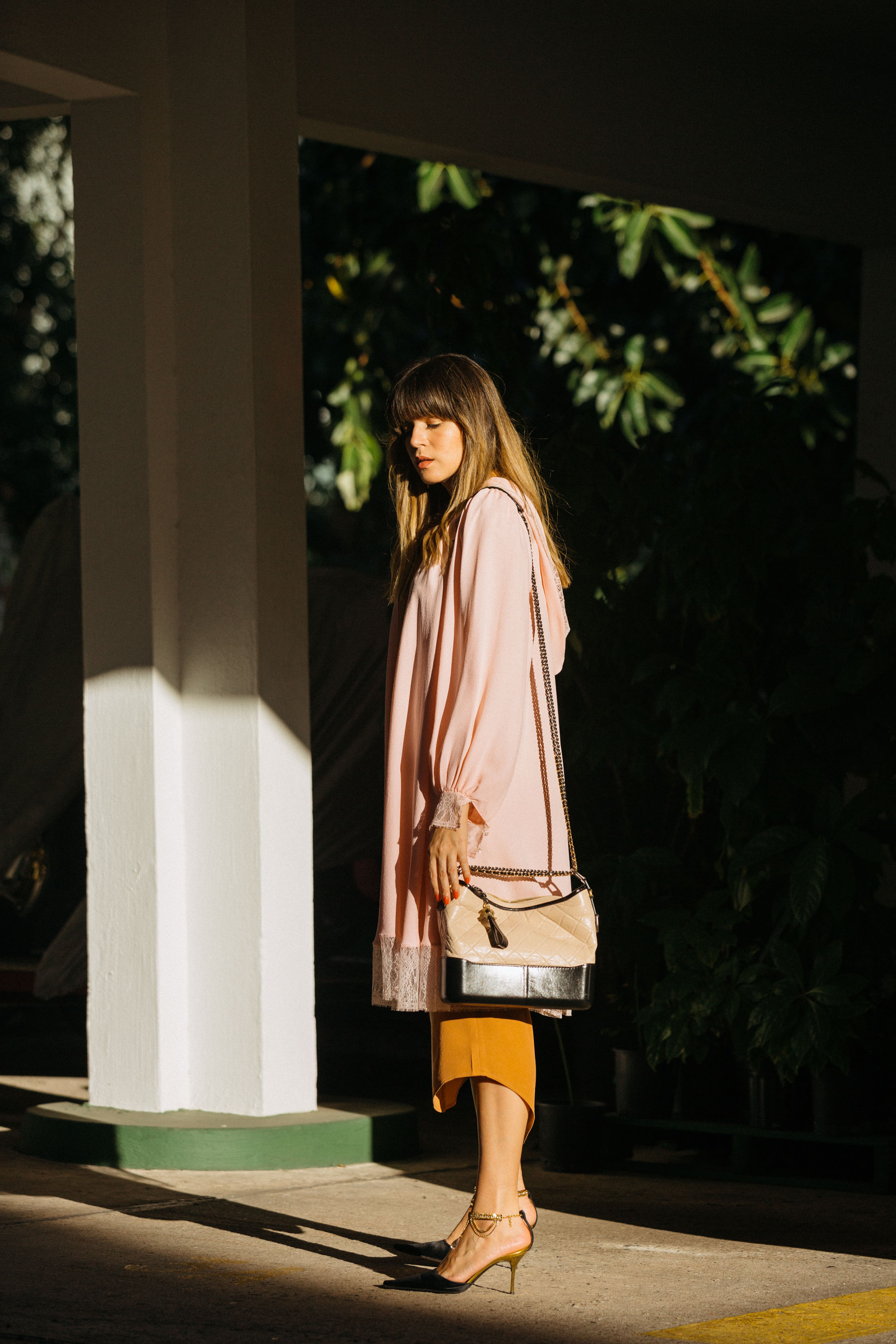 Maristella wears a long silk shirtdress and robe, with Giuseppe Zanotti satin mules with kitten heel and embellished ankle strap