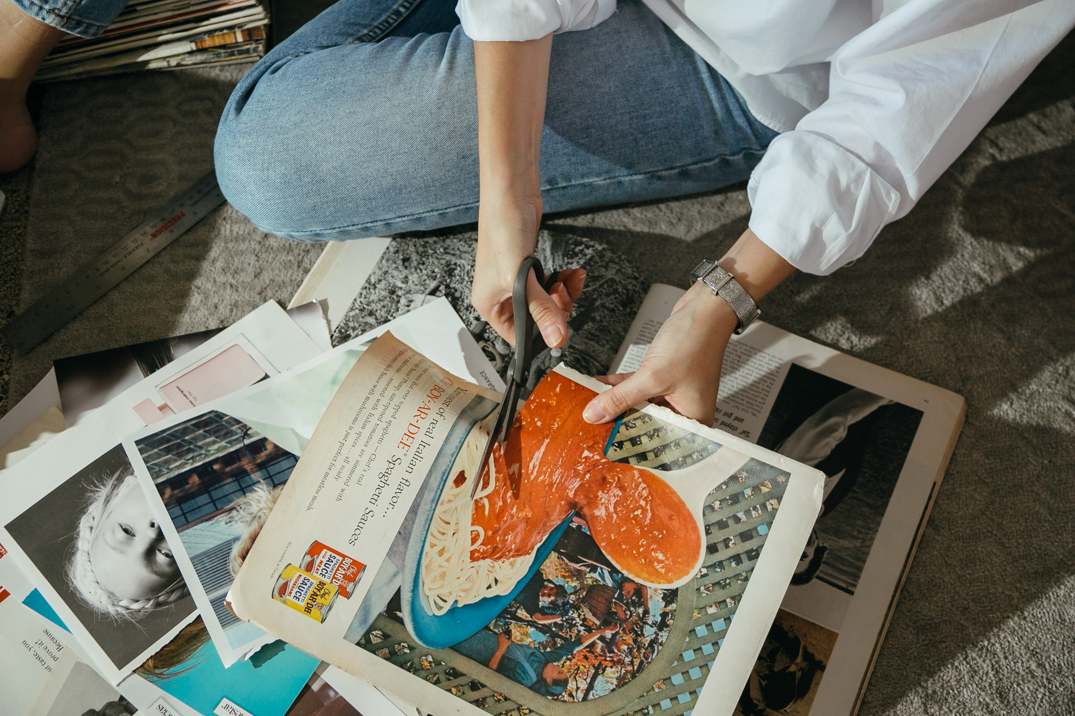 Maristella cuts up a vintage pasta ad in a Life Magazine for one of her collages